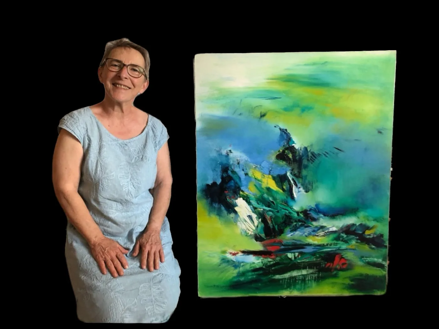 Christine à côté de son tableau abstrait vert et bleu de Régine Gardan